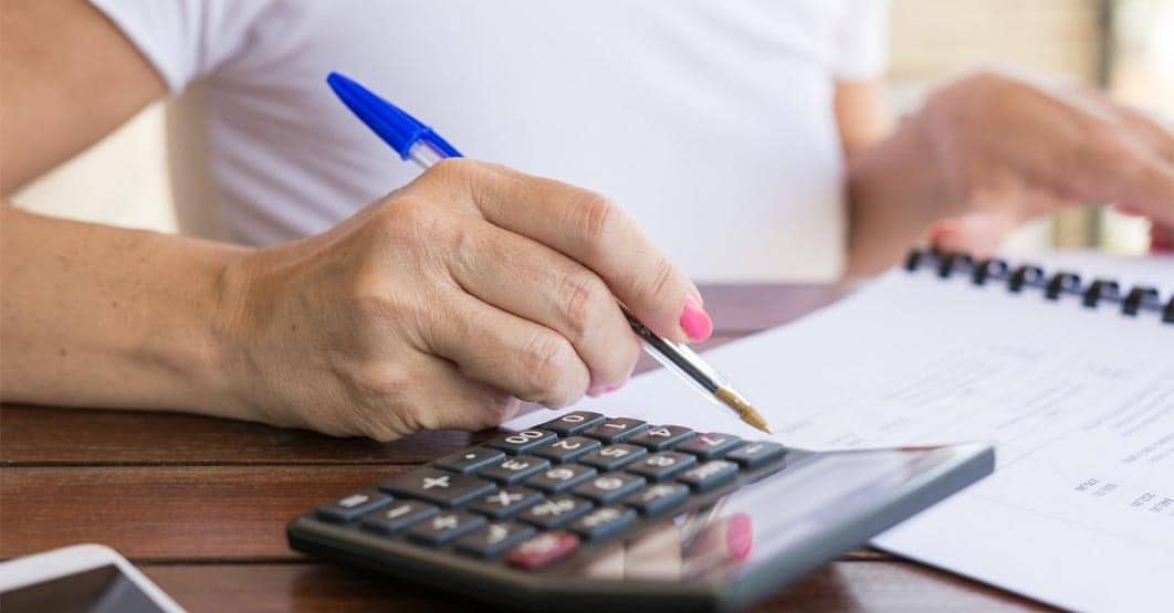 Woman Calculating Dividends
